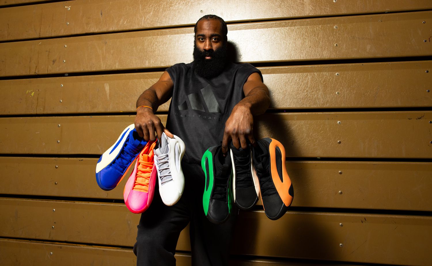James Harden holds six pairs of his multicolor adidas basketball shoes.